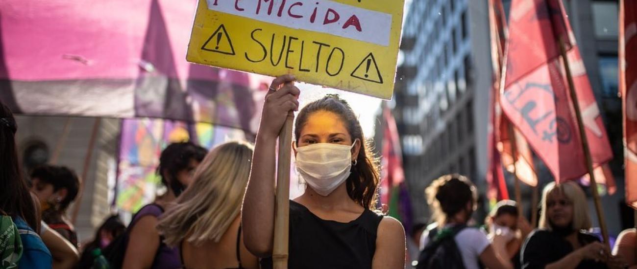 woman with signboard at femicide protest