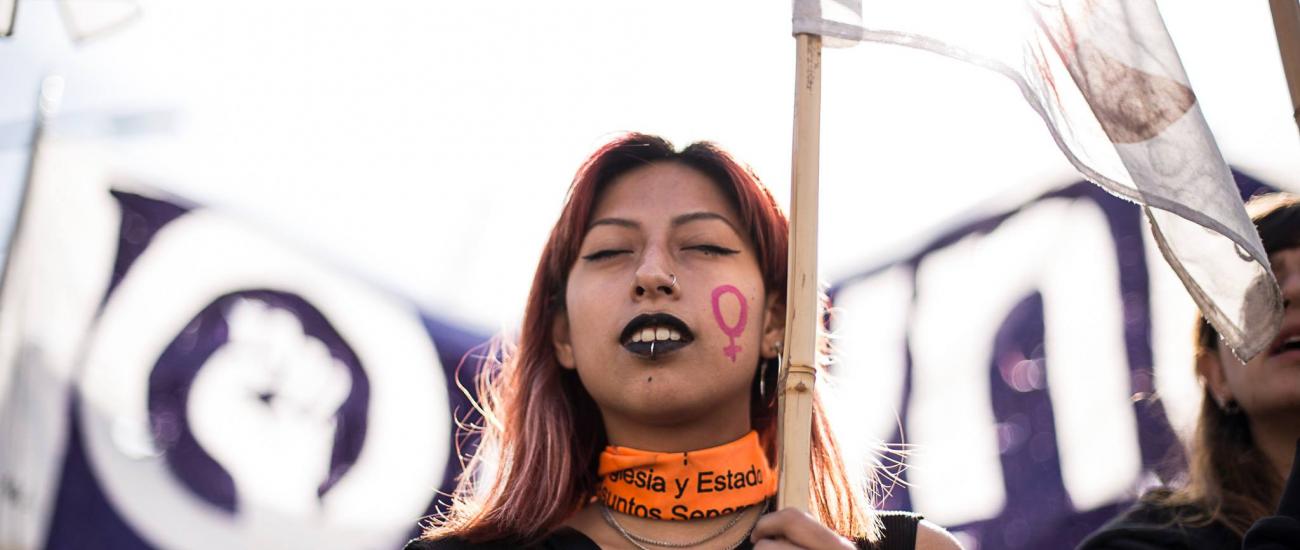 Female femicide protester with flag